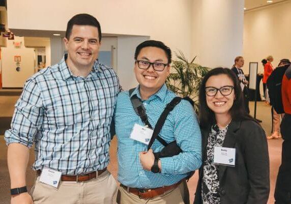 Three smiling people